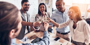 Group of coworkers with champagne glasses, cheering