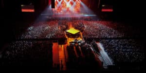 Overhead view of a huge concert at an indoor venue with thousands of fans