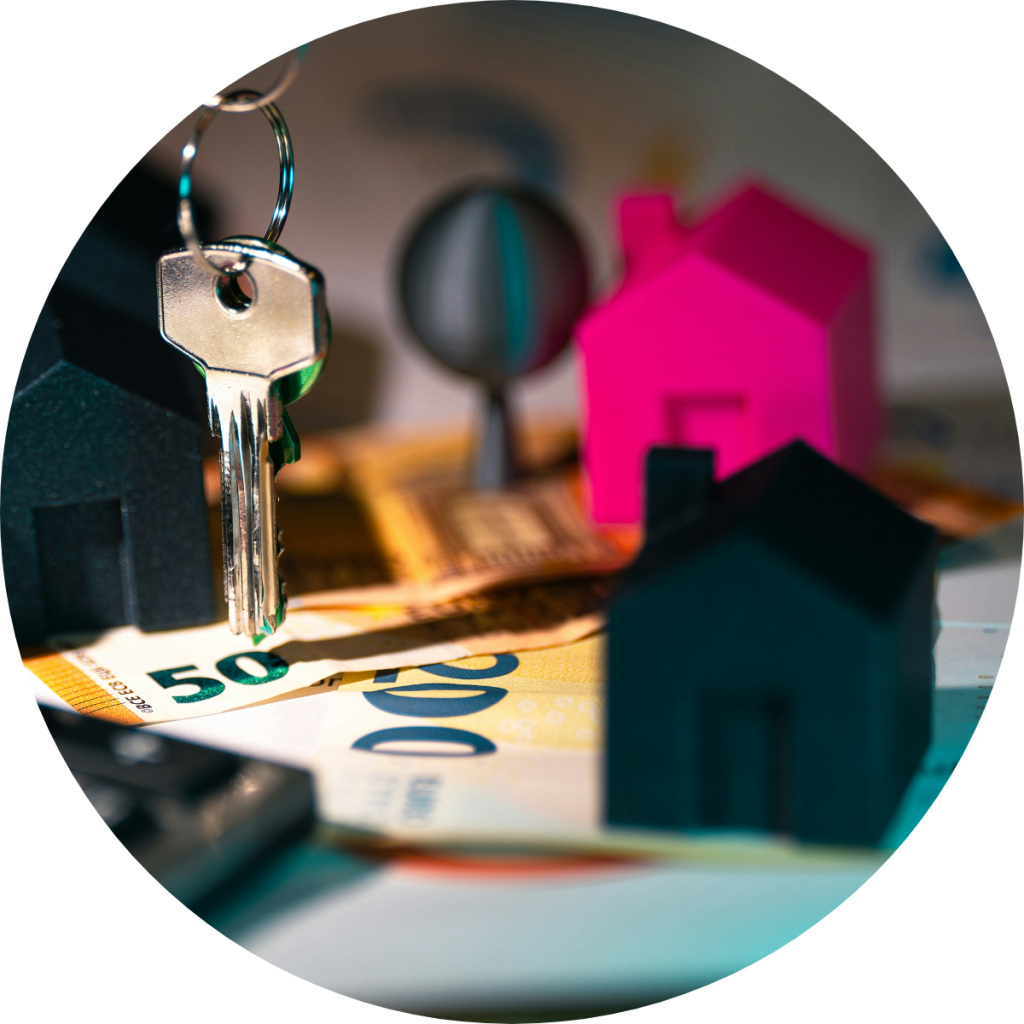 House key with miniature home models and euro banknotes concept image for real estate investment, mortgage financing, property tax deduction, or home purchase financial planning